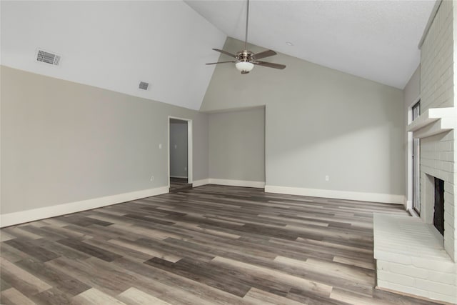 unfurnished living room with high vaulted ceiling, ceiling fan, a brick fireplace, and hardwood / wood-style floors