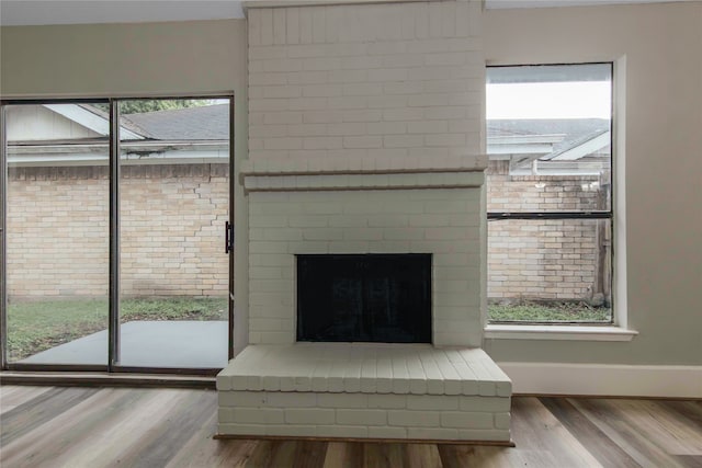 room details featuring a brick fireplace and hardwood / wood-style floors