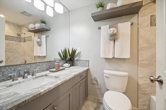 bathroom featuring walk in shower, decorative backsplash, vanity, and toilet