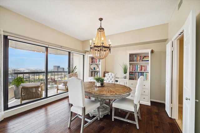 dining area featuring dark hardwood / wood-style flooring and a notable chandelier