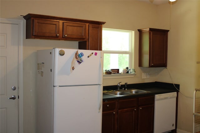 kitchen featuring white appliances and sink