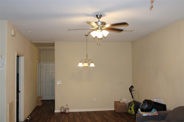 interior space with dark hardwood / wood-style flooring and ceiling fan with notable chandelier