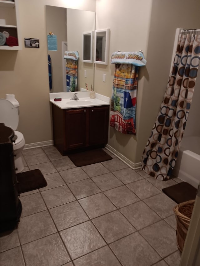 full bathroom featuring shower / bath combination with curtain, vanity, toilet, and tile patterned floors