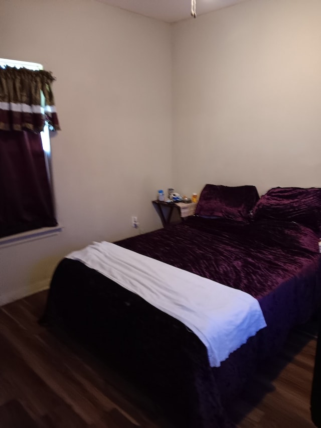 bedroom featuring dark hardwood / wood-style flooring