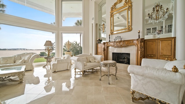 sunroom / solarium featuring a water view and a fireplace