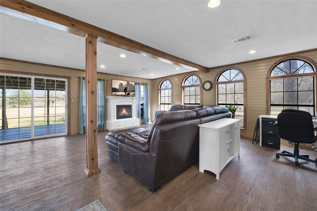 living room with beamed ceiling, decorative columns, and dark hardwood / wood-style floors