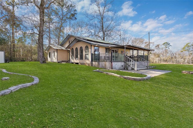 rear view of property featuring a lawn