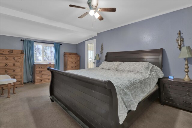 bedroom with ceiling fan, carpet floors, and lofted ceiling