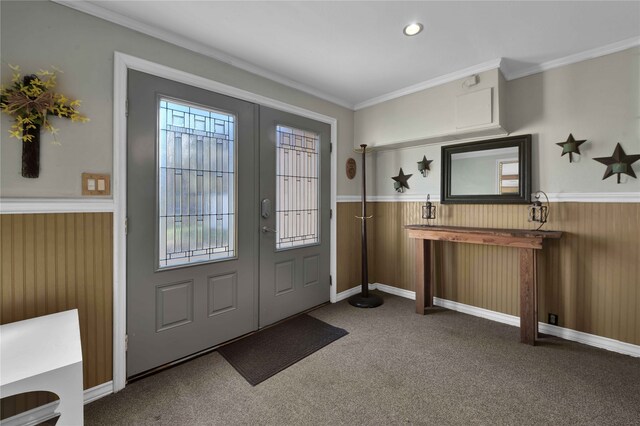 carpeted entryway with crown molding