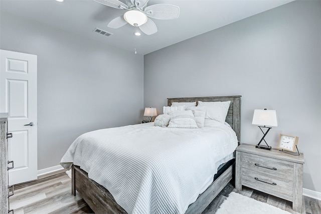 bedroom with ceiling fan and light hardwood / wood-style flooring