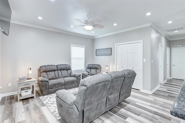 living room with crown molding, light wood-type flooring, and ceiling fan