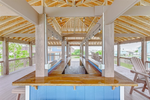 interior space featuring hardwood / wood-style flooring and lofted ceiling with beams