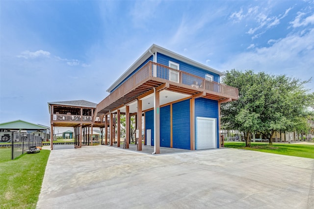 view of front of house with a garage, a carport, and a front lawn