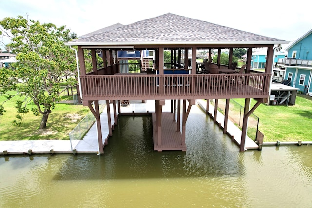 view of dock featuring a lawn and a water view