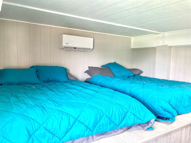 bedroom with an AC wall unit