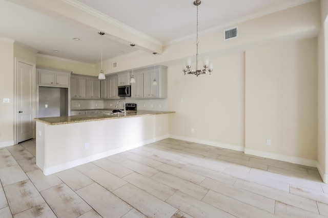 kitchen featuring light stone counters, kitchen peninsula, pendant lighting, and appliances with stainless steel finishes