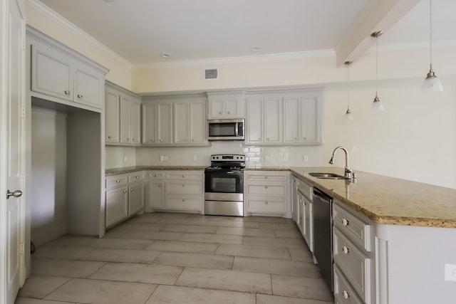 kitchen featuring decorative light fixtures, light stone counters, kitchen peninsula, stainless steel appliances, and sink