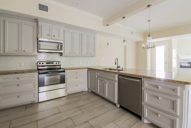 kitchen with tasteful backsplash, beamed ceiling, stainless steel appliances, decorative light fixtures, and sink