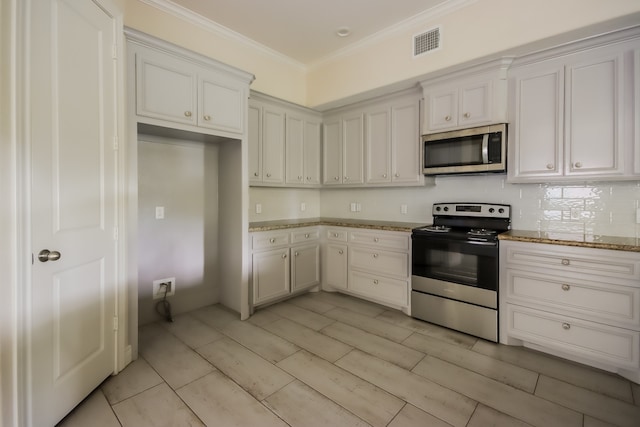 kitchen featuring stainless steel appliances, white cabinetry, backsplash, and crown molding