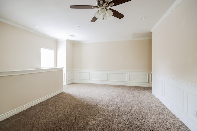 carpeted spare room featuring ceiling fan and crown molding