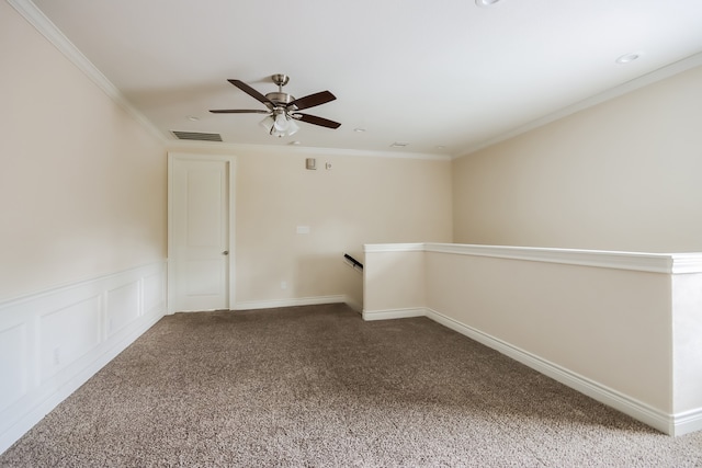 carpeted spare room featuring ornamental molding and ceiling fan