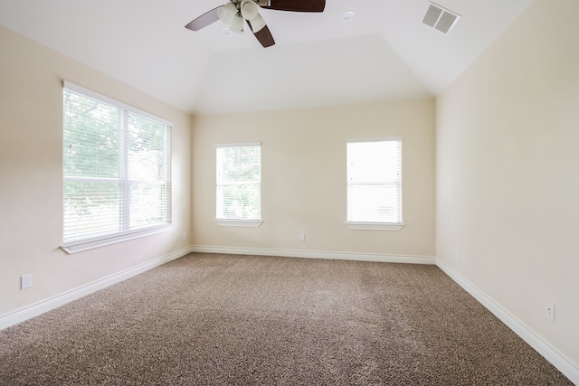 spare room with ceiling fan, lofted ceiling, and carpet flooring