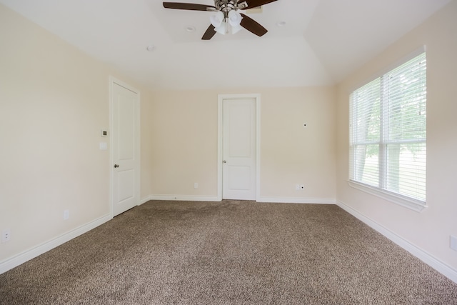 unfurnished room with vaulted ceiling, carpet, and ceiling fan