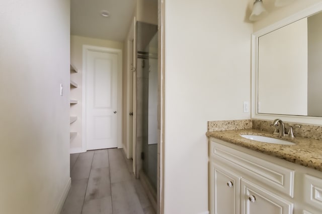 bathroom with hardwood / wood-style floors and vanity