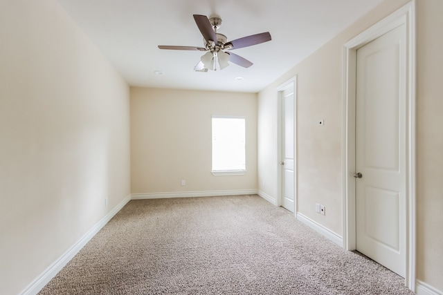 unfurnished room featuring carpet and ceiling fan