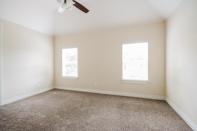 carpeted empty room with ceiling fan and vaulted ceiling