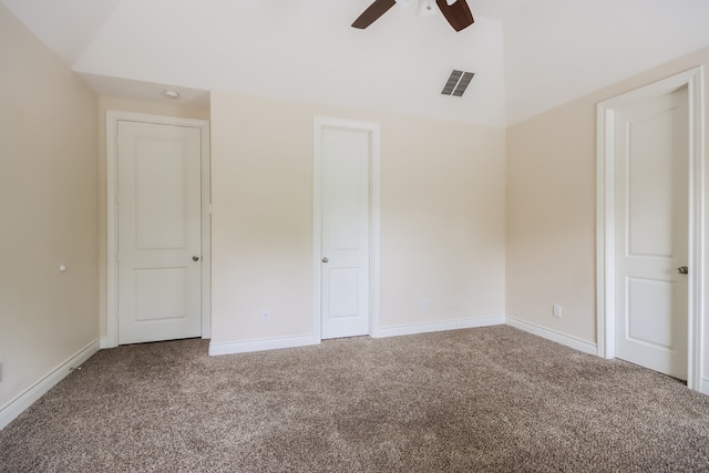 interior space featuring lofted ceiling, carpet floors, and ceiling fan