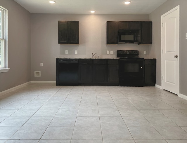 kitchen with black appliances, dark brown cabinetry, sink, and light tile patterned floors