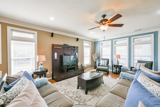 living room with ceiling fan, light hardwood / wood-style flooring, and crown molding