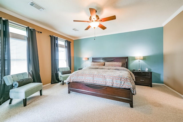 carpeted bedroom with ornamental molding and ceiling fan