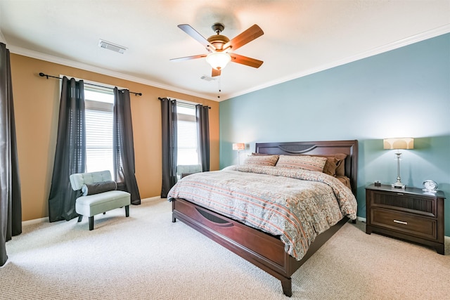 carpeted bedroom with ornamental molding and ceiling fan