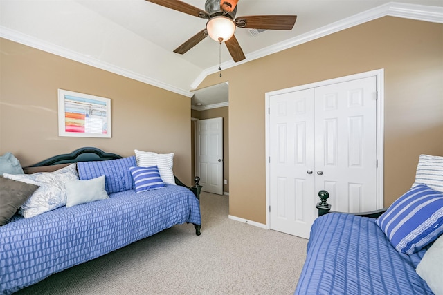 carpeted bedroom featuring lofted ceiling, a closet, ceiling fan, and crown molding