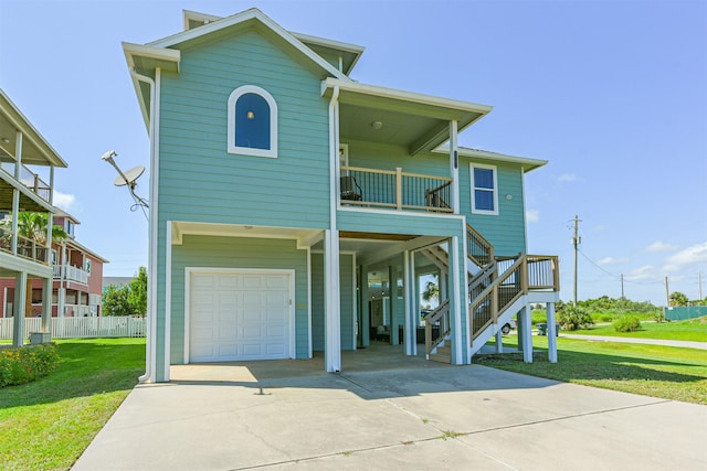 view of front of property featuring a balcony, a front yard, and a garage