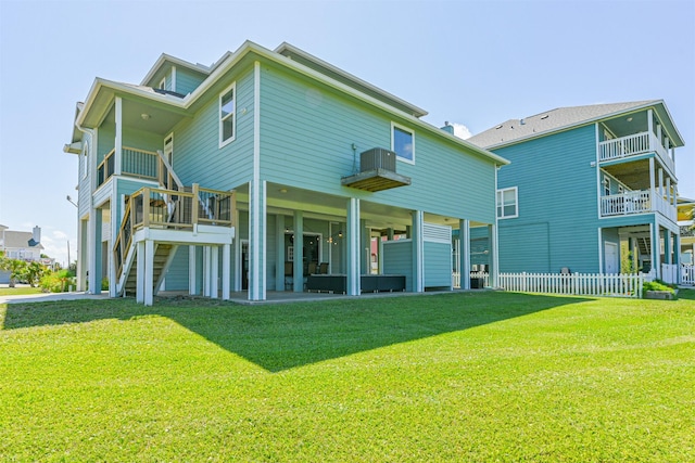 rear view of property featuring a patio and a yard