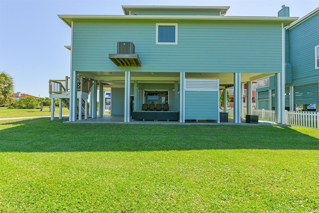 back of property featuring a patio and a lawn