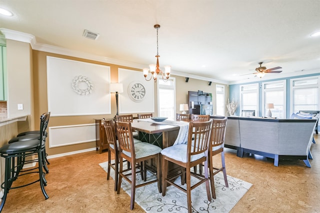 dining space with ornamental molding and ceiling fan with notable chandelier