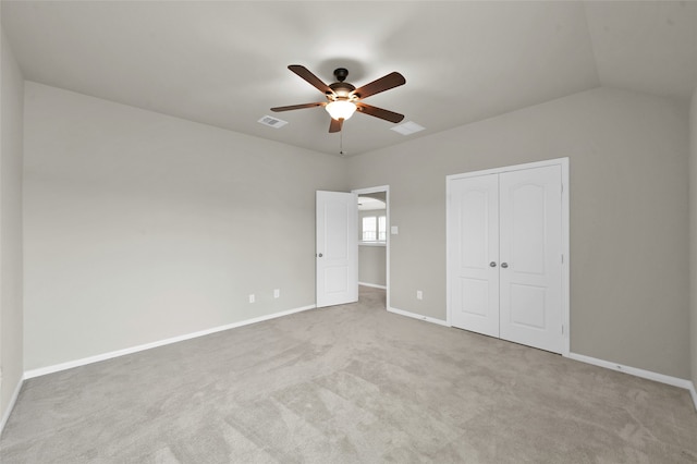 unfurnished room featuring carpet flooring, lofted ceiling, and ceiling fan