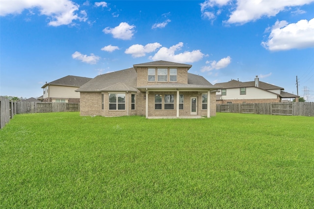 back of house featuring a yard