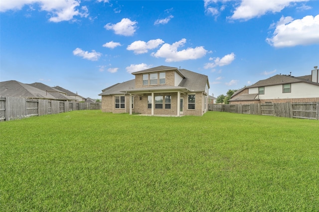 rear view of property with a lawn