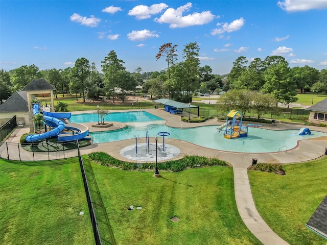 view of pool featuring a water slide, a playground, and a lawn