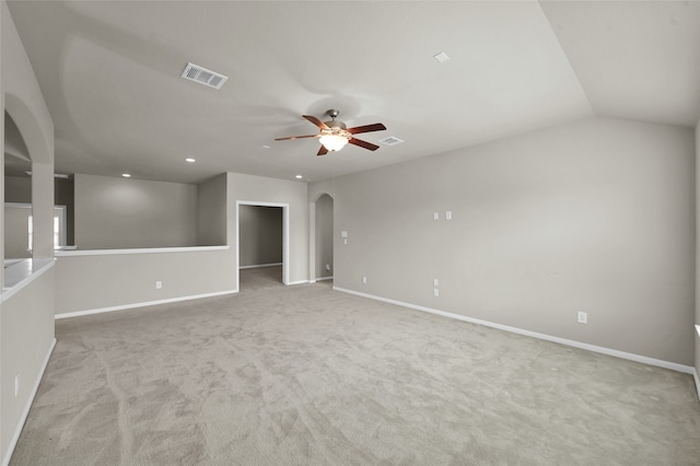 carpeted spare room with vaulted ceiling and ceiling fan