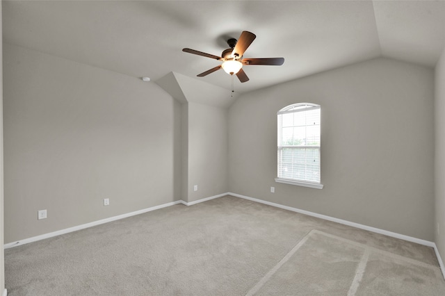 unfurnished room featuring ceiling fan, vaulted ceiling, and carpet floors