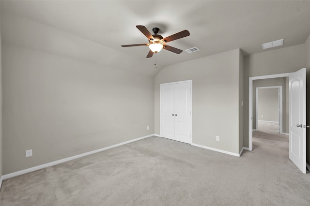 empty room with ceiling fan, light colored carpet, and lofted ceiling