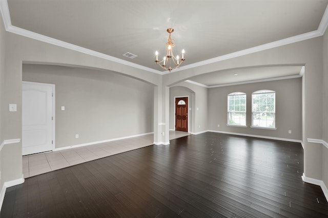 unfurnished living room featuring dark hardwood / wood-style flooring, crown molding, and a chandelier