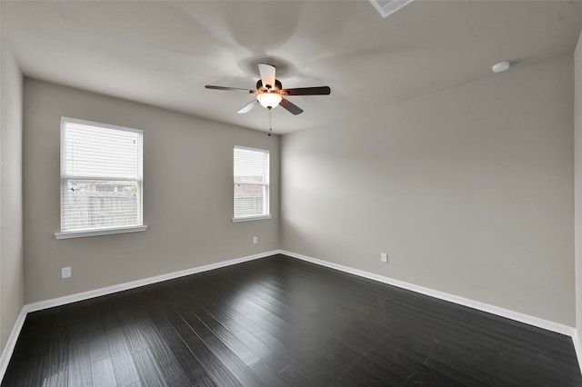 unfurnished room with dark wood-type flooring and ceiling fan