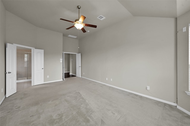 unfurnished bedroom featuring high vaulted ceiling, carpet, ensuite bath, and ceiling fan